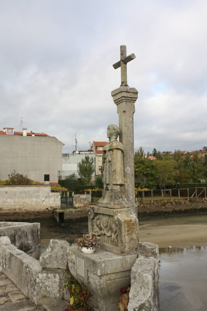 Cruceiro de granito con la figura de San Telmo en el centro del puente de A Ramallosa